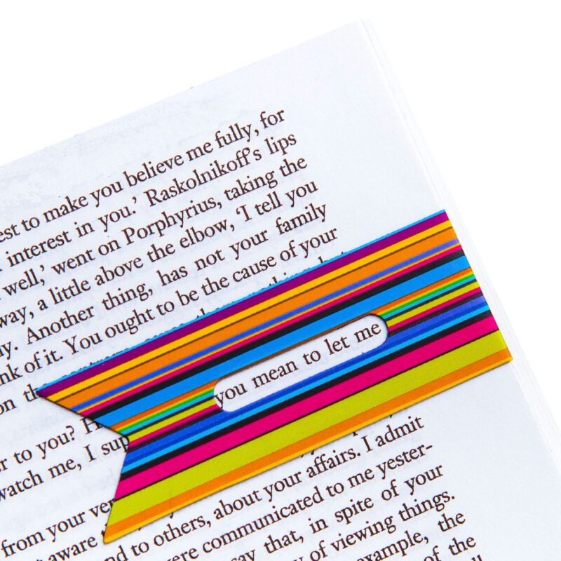 Line marker book mark that you can put over the last line you read to keep a record of where you're up to. Ribbons design. Showing the line marker in use in a book