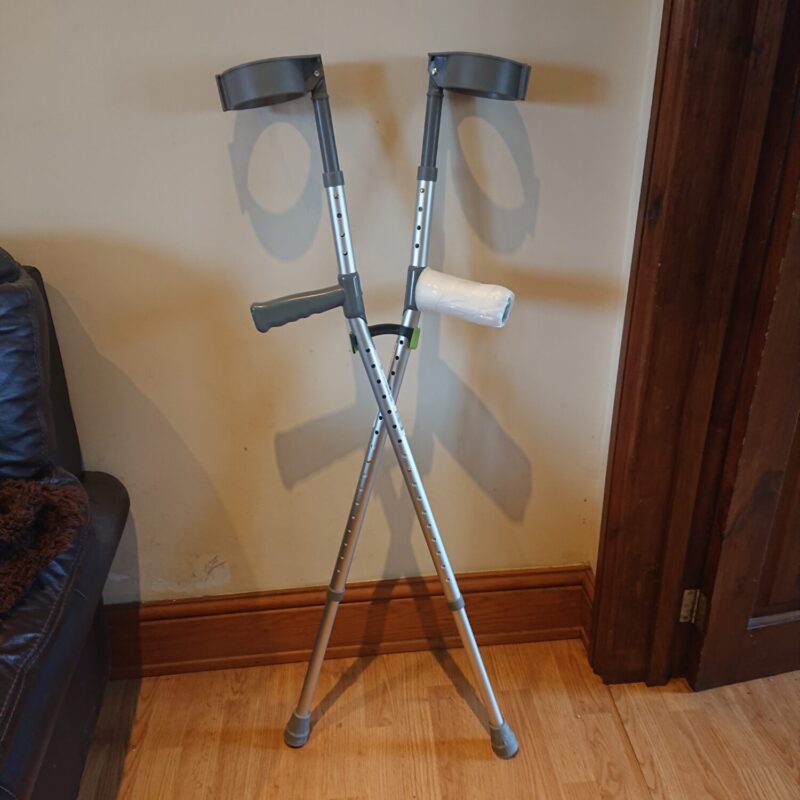 Bridgit stick and crutch clip being used to clip two crutches together