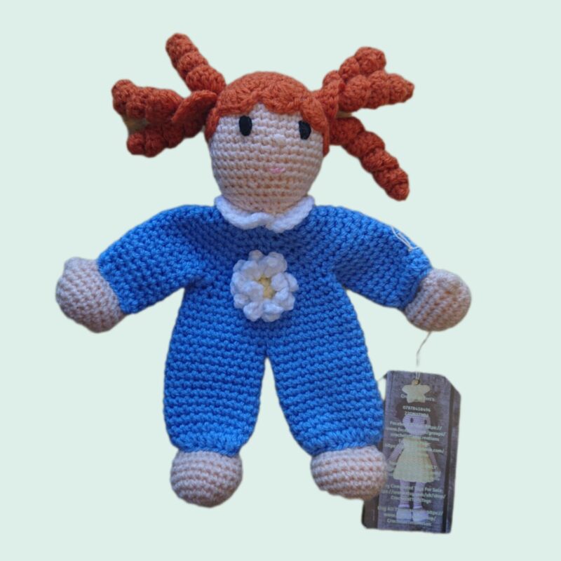 Girl soothing teddy, handmade by crochet. The girl has red curly hair and blue onesie. Designed to sooth or comfort